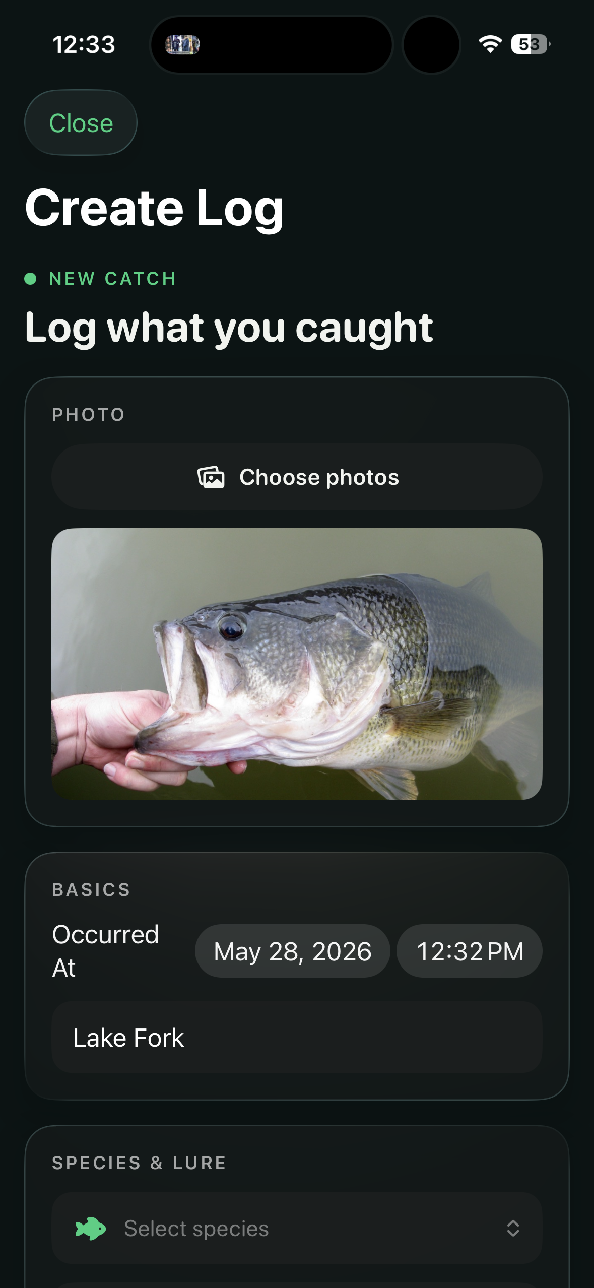 Bass Caddy create-log screen with a photo of a largemouth bass attached, basics auto-filled with Lake Fork and the current date/time, and species and lure fields ready for entry.